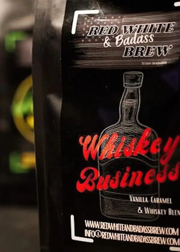 red white badass brew whiskey business with blurred background